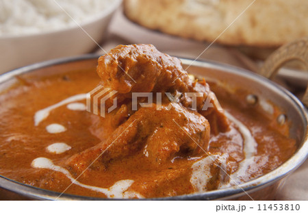 Close-up of butter chicken garnished with cream Close-up of butter chicken garnished with cream 11453810
