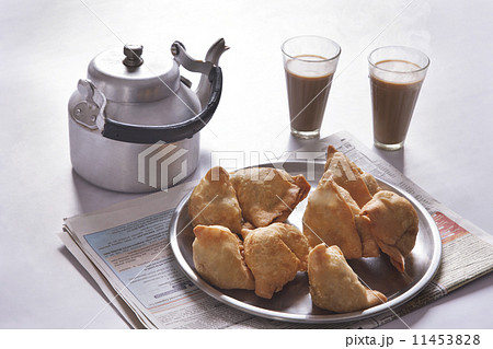 Fresh samosas and tea glasses on table Fresh samosas and tea glasses on table 11453828