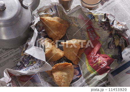 Directly above shot of fresh samosas and tea kettle on table 11453920