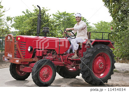 Farmer on a tractor smiling 11454034