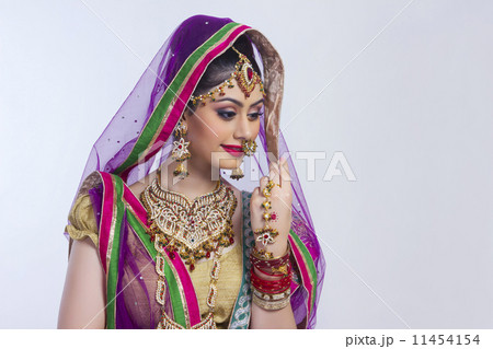 Shy Indian bride against gray background 11454154
