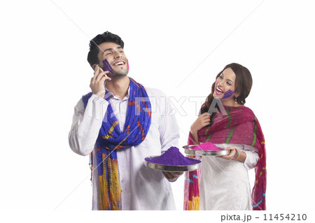 Man with holi colour talking on a mobile phone Man with holi colour talking on a mobile phone 11454210