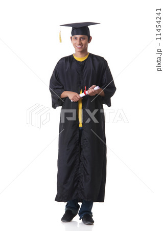Full length portrait of confident graduate student holding diploma against white background Full length portrait of confident graduate student holding diploma against white background 11454241