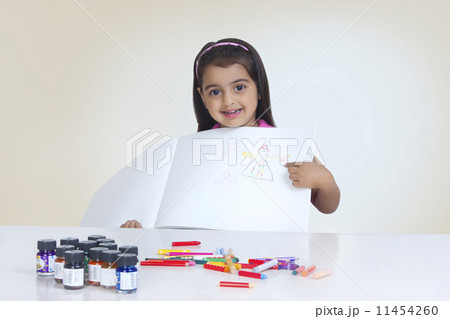 Portrait of girl showing drawing against white background Portrait of girl showing drawing against white background 11454260