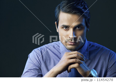 Portrait of confident Indian businessman isolated over black background Portrait of confident Indian businessman isolated over black background 11454270