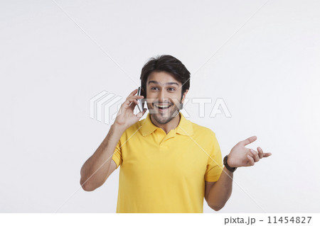 Young man talking on mobile phone Young man talking on mobile phone 11454827