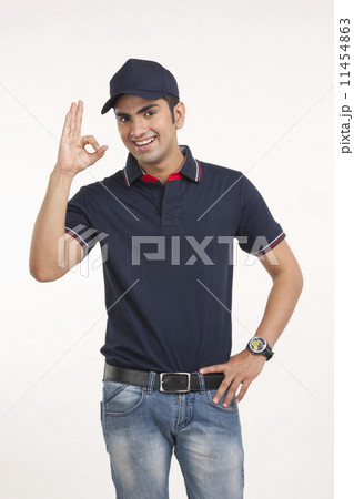 Portrait of happy delivery man gesturing OK sign against white background Portrait of happy delivery man gesturing OK sign against white background 11454863