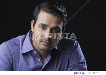 Close-up portrait of handsome Indian businessman over black background 11454986