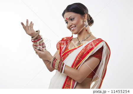 Bengali woman looking at her bangles 11455254