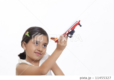 Girl playing with toy aeroplane Girl playing with toy aeroplane 11455327