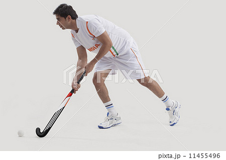 Man playing field hockey over white background Man playing field hockey over white background 11455496
