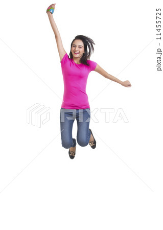 Full length portrait of happy young woman jumping over white background Full length portrait of happy young woman jumping over white background 11455725