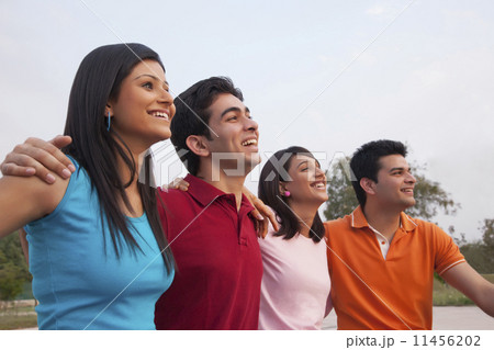 Cheerful friends looking away outdoors 11456202