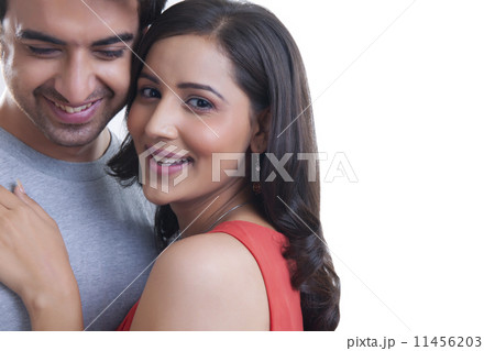 Portrait of happy couple against white background 11456203
