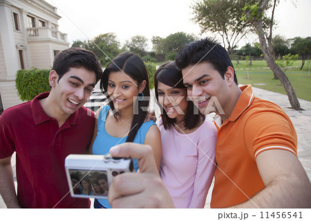 Happy friends taking self portrait outdoors 11456541