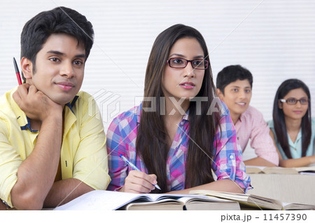 College students listening to lecture in classroom 11457390