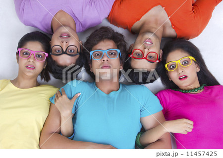 Directly above shot of surprise friends lying over white background 11457425