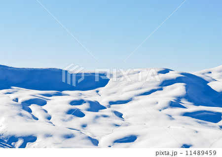 skiing tracks on snow-capped mountains in Alps 11489459
