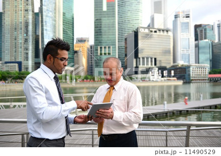 Businessman having discussion using tablet Businessman having discussion using tablet 11490529