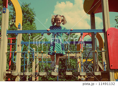 little girl on playground - vintage retro style 11491132