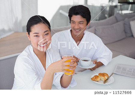 Couple in bathrobes spending the morning together Couple in bathrobes spending the morning together 11527666