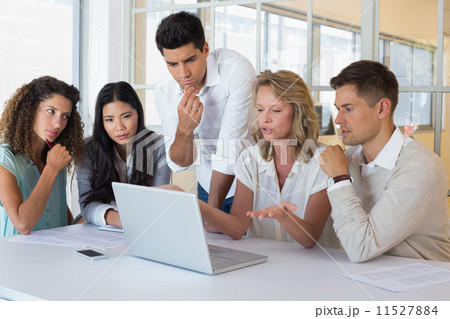 Casual business team having a meeting using laptop 11527884