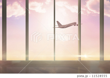 Airplane flying past window at sunrise Airplane flying past window at sunrise 11528555