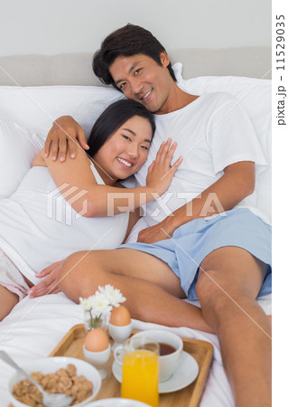 Happy couple having breakfast in bed 11529035