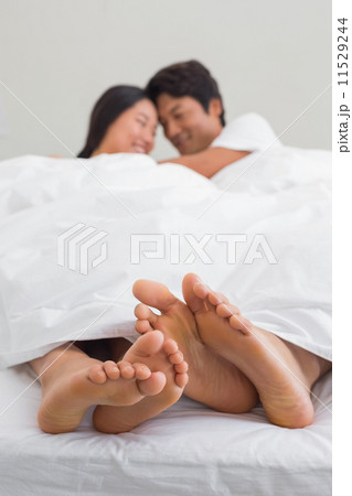 Couples feet sticking out from under duvet Couples feet sticking out from under duvet 11529244