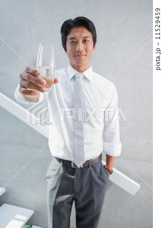 Happy man holding flute of champagne Happy man holding flute of champagne 11529459