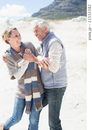 Attractive couple messing about on the beach Attractive couple messing about on the beach 11532382