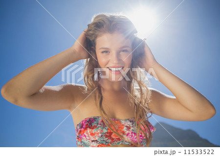 Beautiful smiling blonde in floral bikini on the beach 11533522