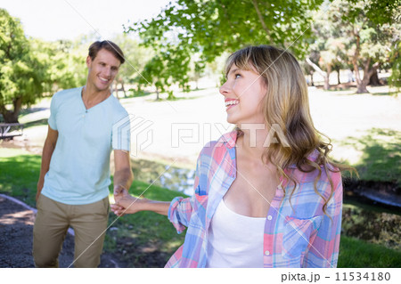 Cute couple walking in the park Cute couple walking in the park 11534180
