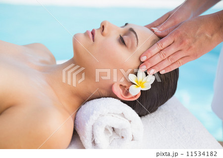 Tranquil brunette getting a head massage poolside Tranquil brunette getting a head massage poolside 11534182