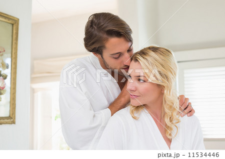 Cute couple in bathrobes spending time together 11534446