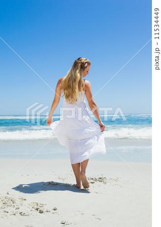 Pretty carefree blonde walking on the beach Pretty carefree blonde walking on the beach 11534449