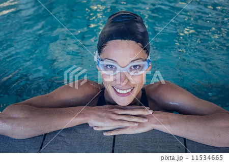 Fit swimmer smiling up at camera in the swimming pool 11534665