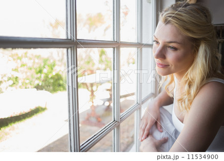 Pretty blonde looking out the window Pretty blonde looking out the window 11534900