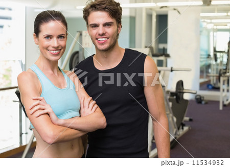Fit man and woman smiling at camera together 11534932