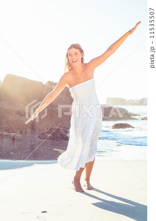 Beautiful happy blonde in white sundress on the beach 11535507
