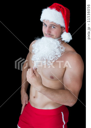 Smiling muscular man posing in sexy santa outfit with fake beard Smiling muscular man posing in sexy santa outfit with fake beard 11536056