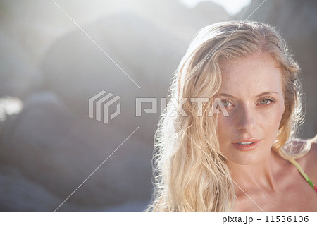 Gorgeous blonde in floral bikini posing on the beach 11536106