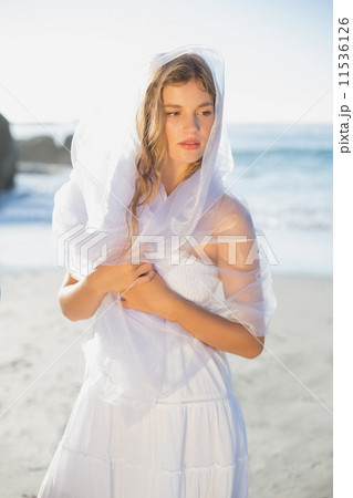 Beautiful blonde in white sundress and scarf on the beach 11536126