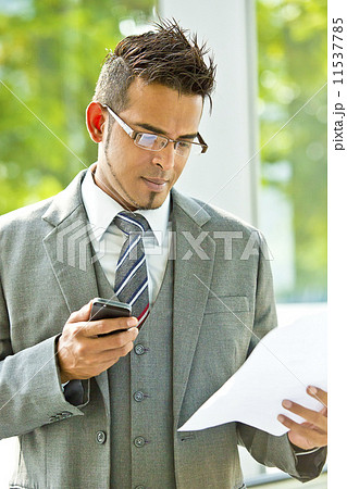 Young businessman using smart phone Young businessman using smart phone 11537785