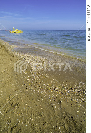 Yellow lifeboat on the beach. 11543112
