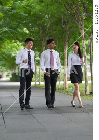 Three young and multi-ethnic co-workers talking in the park 11551250
