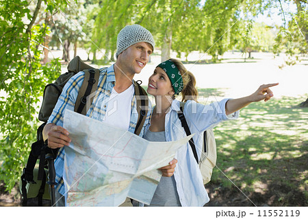 Active couple on a hike consulting the map 11552119