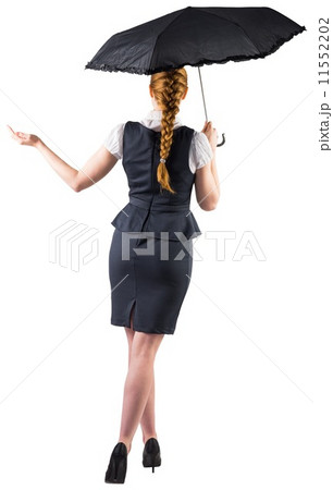 Pretty redhead businesswoman holding umbrella 11552202