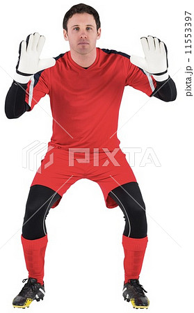 Goalkeeper in red ready to catch 11553397