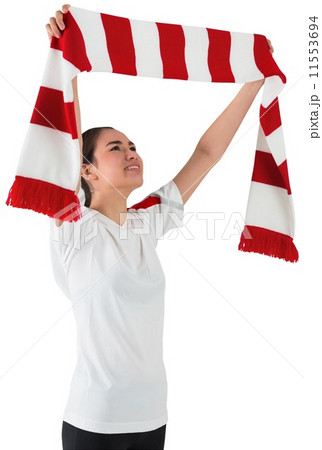 Football fan waving red and white scarf 11553694